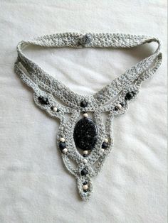 "This is really a lovely combination!! A stunning Annie's pattern, using a soft sage color metallic yarn and a variety of beads. Unique mix of yarn and beads. None are a-like!! No metal, great for those with sensitivities or allergies. The beads are all stitched in securely. Black with gold crackle and white with silver crackle. The back clasp is a button hole style with a glass bead. The center stone is 1.5\" at the longest points. The necklace is 18\" long, opened, end to end. The front drop i Sage Green Necklace, Crocheted Jewelry, Soft Sage Green, Metallic Yarn, Sage Color, Green Necklace, Crochet Jewelry, Stone Pendant, Stone Pendants