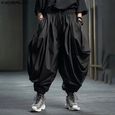 SPECIFICATIONS Brand Name: INCERUN Applicable Season: Four Seasons Origin: Mainland China CN: Guangdong Material: POLYESTER Applicable Scene: CASUAL Pant Style: Wide leg pants Style: Casual Craft of Weaving: TAT Model Number: Solid Color Men Irregular Pants Thickness: midweight Waist Type: MID Decoration: none Gender: MEN Item Type: full length Place Of Origin: China (mainland) Closure Type: Elastic Waist Fabric Type: Broadcloth Length: full length Front Style: Pleated Fit Type: LOOSE Color: Black,Khaki,Grey Size: S,M,L,XL,2XL,3XL,4XL,5XL,Plus Size {custom} Size:S,M,L,XL,2XL,3XL,4XL,5XLFabric Material:100%PolyesterColor:Black,Khaki,GreyOccasion:LeisurePattern:Solid colorProduct Description:Men's Solid Color Harem Pants Baggy Techwear Harem Pants, Black Harem Pants With Pockets For Streetwear, Black Hip Hop Harem Pants With Pockets, Baggy Black Harem Pants For Summer, Black Harem Bottoms For Spring, Black Harem Parachute Pants With Pockets, Black Drop Crotch Bottoms For Summer, Baggy Black Harem Pants With Pockets, Black Baggy Harem Pants