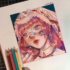 a drawing of a girl with pink hair and blue eyes is next to colored pencils