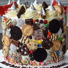 a decorated birthday cake with lots of cookies and candy