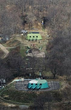 an aerial view of a skate park in the woods