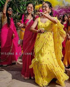 two women in yellow and pink sari dancing