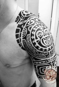 a man's arm with an intricate tattoo design on his left shoulder and chest