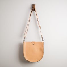 "With a classic saddle bag shape and convenient, magnetic snap closure, this is your new go-to bag. Easily fit everyday items including wallets, keys, phone, and more. We hand-cut buttery soft yet durable 5 oz Horween leather and stitch it with heavyweight nylon thread. The crossbody straps are available in multiple color options and are fitted with solid brass hardware. * Approximately 10\" x 10\" x 2\" * Crossbody strap drop adjusts from 16\" - 28\" * Magnetic snap closure * Unlined interior" Saddle Crossbody Bag, Crossbody Saddle Bag, Personalized Leather Wallet, Chestnut Leather, Slim Leather Wallet, Horween Leather, Leather Saddle Bags, How To Make Handbags, Leather Crossbody Purse