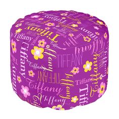 a purple flowery pouff with words all over it