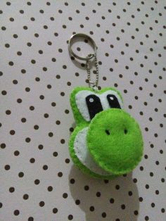 a keychain with a green and white animal on it