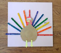 a turkey made out of crayons sitting on top of a piece of paper