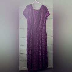 This Evening Dress Screams Royalty And Class. I Love The Lace Fabric And This Gown Fully Lined. Great For Wedding And Also For Any Formal Occasions . Short Sleeved And Fully Lined. Ptp: 19” Stretch Up To 23” Length: 52” Purple Short Sleeve Maxi Dress For Wedding, Purple Short Sleeve Wedding Dress, Fitted Purple Gown For Mother Of The Bride, Purple Lace Floor-length Gown, Purple Embroidered Floor-length Gown, Purple V-neck Floral Lace Dress Mother Of The Bride, Alex Evenings, Purple Lace, Formal Occasion