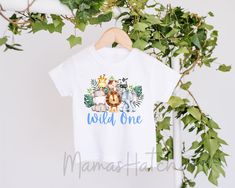 a white t - shirt with the words wild one printed on it and two giraffes