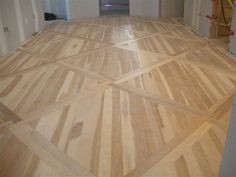 an empty room with hard wood flooring in the process of being remodeled and painted