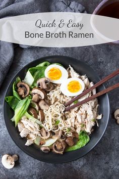 a bowl filled with noodles and mushrooms next to chopsticks on top of a table