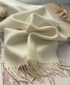 Our 100% solid Baby Alpaca scarf is a great gift for men or women.   Wrapped in a 100% recycled cotton bag (included), our winter wool scarf makes the perfect addition to any wardrobe.   Optional Gift wrapping in a box available at checkout. MEASUREMENTS: 70.5 inches by 11.5 inches (180 cm by 30 cm). We also carry other genuine Peruvian Royal Alpaca scarves at: https://www.etsy.com/listing/1070206854/royal-alpaca-scarf-men-wool-scarf-gift Baby Alpaca's wool is warmer than other wools and contain Classic White Scarf For Gift, Classic Beige Shawl For Winter, Classic Solid Pashmina Shawl, Classic Solid Color Winter Shawl, White Winter Scarf, Alpaca Scarf, Well Woven, Dressy Fashion, Great Gifts For Men