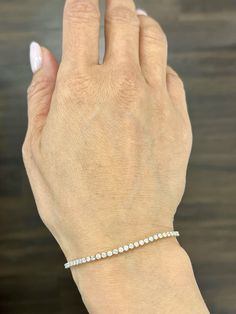 This beautiful delicate diamond tennis bracelet weights 2.50 ct and showcases 70 round diamonds. The diamonds boast a color of G/H and S12/I1 in color. A great bracelet if you are starting your jewelry collection. White Diamond Bracelet With Single Cut Diamonds, Dazzling White Diamond Bracelet With Single Cut Diamonds, White Tennis Bracelet With Single Cut Diamonds, White Diamond Bracelet With Prong Setting, Fine Jewelry White Diamond Bracelet With Prong Setting, White Diamond Bracelet With Accents, White Diamond Bracelet With Vvs Clarity, White Brilliant Cut Tennis Bracelet, White Round Cut Diamond Bracelet