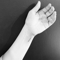 a person's arm with a small tattoo on it