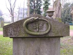 an old grave with a face carved into it