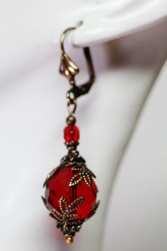 I created these Red Victorian Style Earrings with Red Czech beads and I accented them with Antiqued Brass bead caps. The earrings are just under 2 inches long and come in a gift bag or gift box. Red Single Hoop Earring For Party, Red Drop Clip-on Earrings As Gift, Red Drop Clip-on Earrings For Gift, Handmade Red Crystal Drop Earrings, Handmade Red Earrings For Formal Occasions, Red Teardrop Pierced Jewelry, Elegant Red Metal Hoop Earrings, Red Drop Earrings For Party, Handmade Red Hoop Earrings For Party