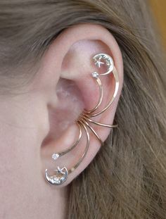 This beautifully spectacular ear cuff is bound to make a statement for you Celestial Jewelry lovers! This Ear Cuff decorates the ear from top to bottom. It hugs the ear in the center of the ear comfortably and securely without piercing and decorates the entire ear. We use only the highest quality materials 14K Gold Filled and Sterling Silver. This item will ship in a Gift Box with easy fitting instructions. Ready for gift giving! Moon Phases Jewelry, Moon Phase Jewelry, Double Ear Piercings, Star And Moon, Sun Moon Stars, Ear Climbers, Celestial Jewelry, Moon And Star, Ear Piercing