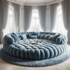 a round couch with pillows on top of it