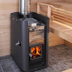 a wood burning stove in the corner of a room next to a bench with benches