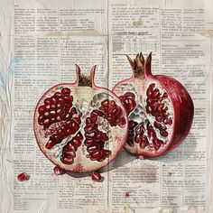 two pomegranates cut in half sitting on top of an old newspaper