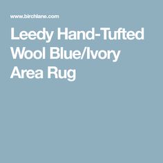 the words leedy hand - tuffed wool blue / ivory area rug are shown