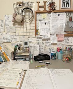 a cluttered desk with many papers on it