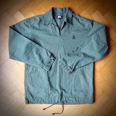 Rare vintage STUSSY quarter-zip overshirt in heavyweight woven cotton from early 90s. Green and black check with metal zip, buttoned cuffs and cord drawstring with toggles at the bottom edge. Unlined, with large set-in pockets and double panel at back neck. Stussy Broken Crown logo embroidery at the chest. Made in USA. In very good pre-loved condition. Size: Men's S Measurements: chest from underarm to underarm 23 inches Length at back from neck to edge of bottom hem 30 inches. Length of sleeve Retro Cotton Windbreaker For Streetwear, Vintage Cotton Windbreaker For Streetwear, Retro Cotton Windbreaker With Pockets, Retro Cotton Windbreaker For Outdoor, Collared Cotton Windbreaker For Outdoor, Vintage Stussy, Comfortable Skirts, Crown Logo, Early 90s