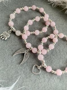 𝑅𝑜𝓈𝑒 𝒬𝓊𝒶𝓇𝓉𝓏  Handmade bracelet using Rose Quartz crystal 8mm beads and silver plated spacer beads with any choice of charm 💗 (Please state in personalisation box or note to seller which charm you would like if not listed) 𝑅𝑜𝓈𝑒 𝒬𝓊𝒶𝓇𝓉𝓏 is a peaceful and loving crystal and the stone of universal love. It restores trust and harmony in relationships, encouraging unconditional love. Rose Quartz purifies and opens the heart at all levels to promote love, self-love, friendship, deep Silver Charm Bracelet With Gemstone Beads As Gift, Silver Rosary Bracelet With Gemstone Beads, Silver Rosary Bracelet With Gemstone Beads As Gift, Silver Rose Quartz Bracelet With 8mm Beads, Silver Beaded Rose Quartz Bracelets, Silver Crystal Bracelet With Rose Quartz Round Beads, Pink Sterling Silver Crystal Bracelet As A Gift, Silver Rose Quartz Bracelet With Round Beads, Silver Stretch Bracelet With 8mm Beads For Gift