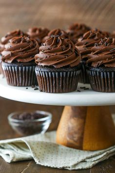 cupcakes with chocolate frosting on a cake plate