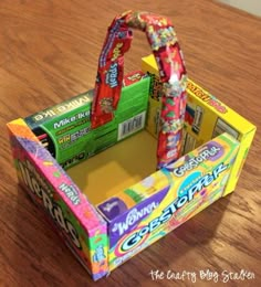 an empty candy box sitting on top of a wooden table