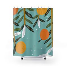 a shower curtain with oranges and leaves printed on the outside, hanging from a metal rod