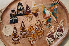 a wooden tray topped with lots of beaded items