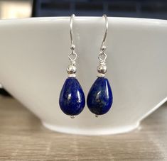 Lapis Lazuli Gemstone Sterling Silver Earrings - I made the earrings with 10mm x 15mm teardrop shape royal blue Lapis Lazuli semi precious gemstones, I wire- wrapped with Sterling Silver wire and Sterling Silver beads.  The earrings hang from .925 Sterling Silver earwires. The earrings measure 35mm long including the earwires The Lapis stones are dark royal blue colour with flecks of gold pyrite through the stones. All metal is .925 Sterling Silver I will send your earrings wrapped in crisp whit Blue Gemstone Teardrop Earrings, Blue Lapis Lazuli Teardrop Earrings, Blue Teardrop Lapis Lazuli Earrings, Sapphire Teardrop Lapis Lazuli Jewelry, Classic Blue Teardrop Earrings, Lapis Lazuli Teardrop Jewelry With Matching Earrings, Teardrop Lapis Lazuli Jewelry With Matching Earrings, Sapphire Teardrop Gemstone Earrings, Sapphire Teardrop Earrings For Gift