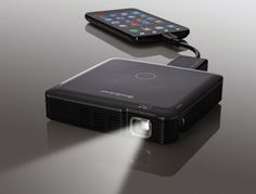 an image of a projector with a phone on the top and another device below it