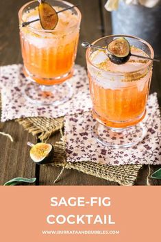 two glasses filled with orange cocktail on top of a wooden table