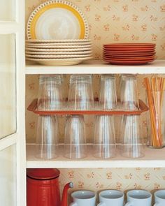 a shelf filled with dishes and cups on top of it