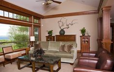 a living room filled with furniture and large windows