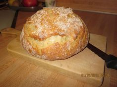 a loaf of bread sitting on top of a cutting board