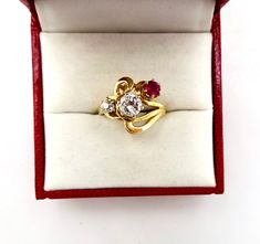 Contemporary Estate Custom 14K 585 Yellow Gold Diamond & Ruby Ring, Size 5 1/2. This is a custom made ring from three antique stones. The center largest stone is a 1/2 Carat Diamond. Flanked by a .20 Carat European Cut Diamond and a 1/4 carat antique ruby. Stunning design and color. The largest diamond is nearly flawless. The smaller diamond has a tiny chip. Would make a very creative engagement ring. The ring is hallmarked 14K for gold content. Weighs 4.3 grams. Excellent clean condition. C Vintage Yellow Gold Three-stone Jewelry, Vintage Yellow Gold Three Stone Jewelry, Heirloom Three Stone Ruby And Diamond Ring, Heirloom Three Stone Ruby Ring With Diamonds, Heirloom Yellow Gold Three Stone Ring, Heirloom Three-stone Ruby Ring With Diamonds, Heirloom Three-stone Ruby And Diamond Ring, Antique Three Stone 14k Gold Jewelry, Victorian Three Stone 14k Gold Ring