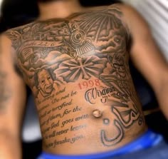 the back of a man's chest with tattoos on it and words written in different languages