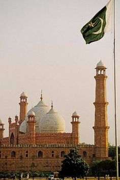 an old building with a flag flying in front of it