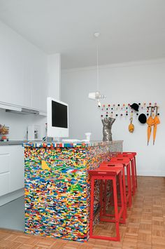 there are many lego stools in this kitchen