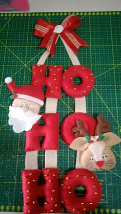 the letters are made out of felt and decorated with santa claus, reindeer, and snowman