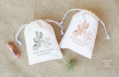 two small drawsacks with cactus designs on them, one has a wine bottle and the other has a cork