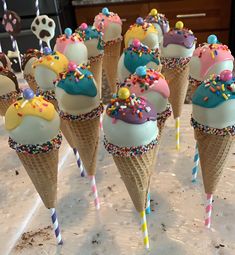 there are many ice cream cones with sprinkles on them