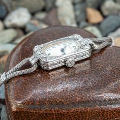 This old platinum and diamond watch features old European and single cut diamond accents. The face of the watch is signed Marcus & Co, and the movement is signed Cresarrow W. Co. The movement has 18 jewels and 3 adjustments. The watch is on a 10k white gold diamond band that is finished with a white metal clasp. The back case of the watch has a monogram of "H.V.B.J." As of this writing, the watch currently ticks and can keep time for at least a few hours, but that could change at any moment. We do not offer any warranty on watch movements. White Gold Diamond Band, Art Deco Watch, Gold Diamond Band, The Movement, Women Wrist Watch, Girly Jewelry, Diamond Watch, Diamond Band, Watch Movement