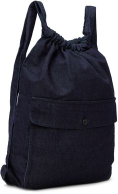 Denim backpack in blue. · Fading throughout · Adjustable shoulder straps · Flap pocket at face · Drawstring closure · Unlined · H19 x W15.5 x D2 Part of the O-Project collection. Supplier color: Indigo blue Casual Backpack With Pockets For On-the-go, Everyday Denim Blue Backpack, Denim Travel Bag With Adjustable Strap, Travel Denim Bag With Adjustable Strap, Denim Blue Travel Backpack, Denim Blue Standard Backpack For Travel, Denim Travel Backpack With Pockets, Travel Backpack With Pockets In Denim, Daily Use Denim Blue Backpack With Pockets