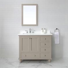 a bathroom vanity with two sinks and a mirror on the wall next to a white brick wall