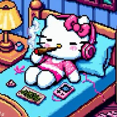 the hello kitty is laying in her bed with headphones and an alarm clock on it