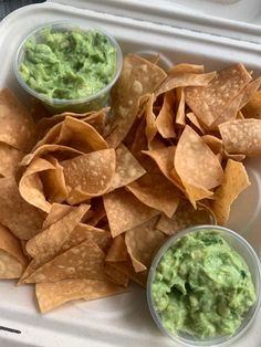 some tortilla chips and guacamole in a plastic container